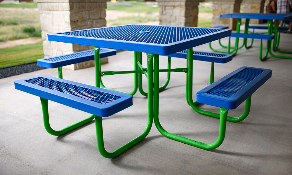 Blue expanded metal surface mount picnic table with green frame designed for commercial parks, schools, and outdoor recreation facilities